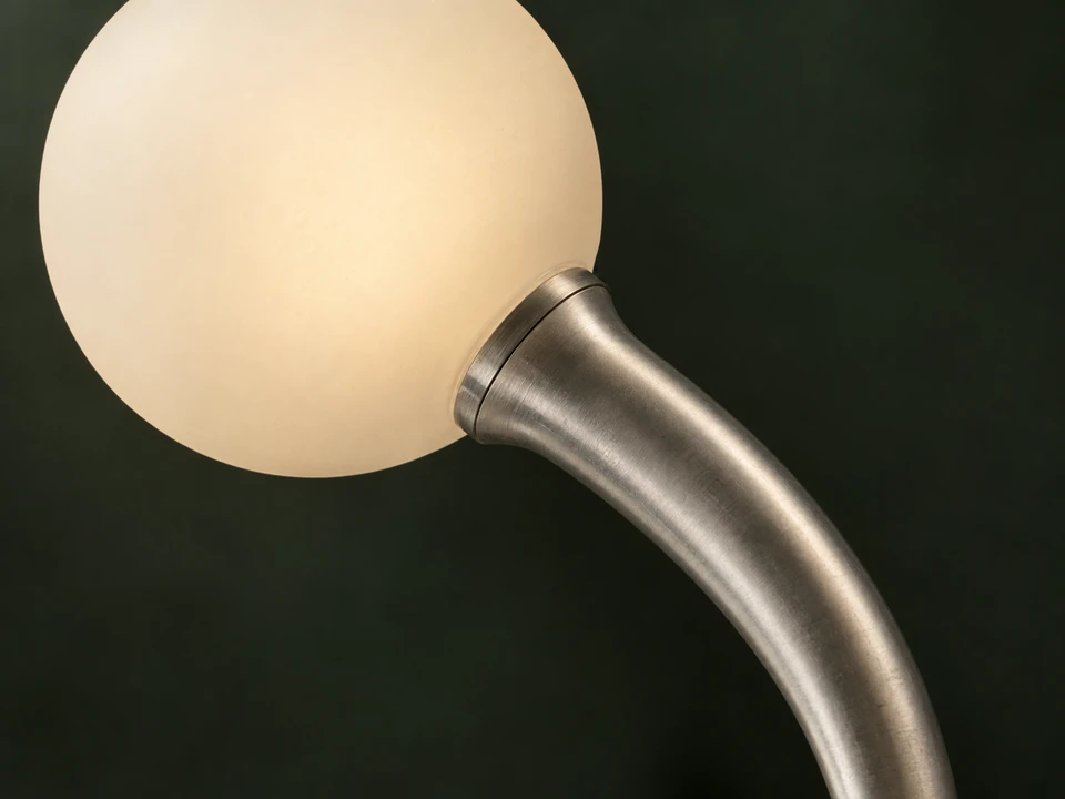 Detail image of a sculptural aluminium and opal glass lamp