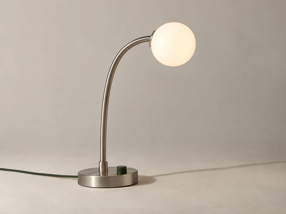 Product image of a sculptural aluminium and opal glass lamp